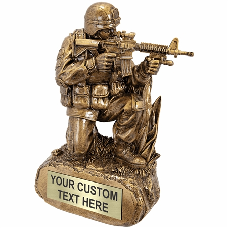 Antique gold military resin trophy featuring kneeling soldier in grass with rifle